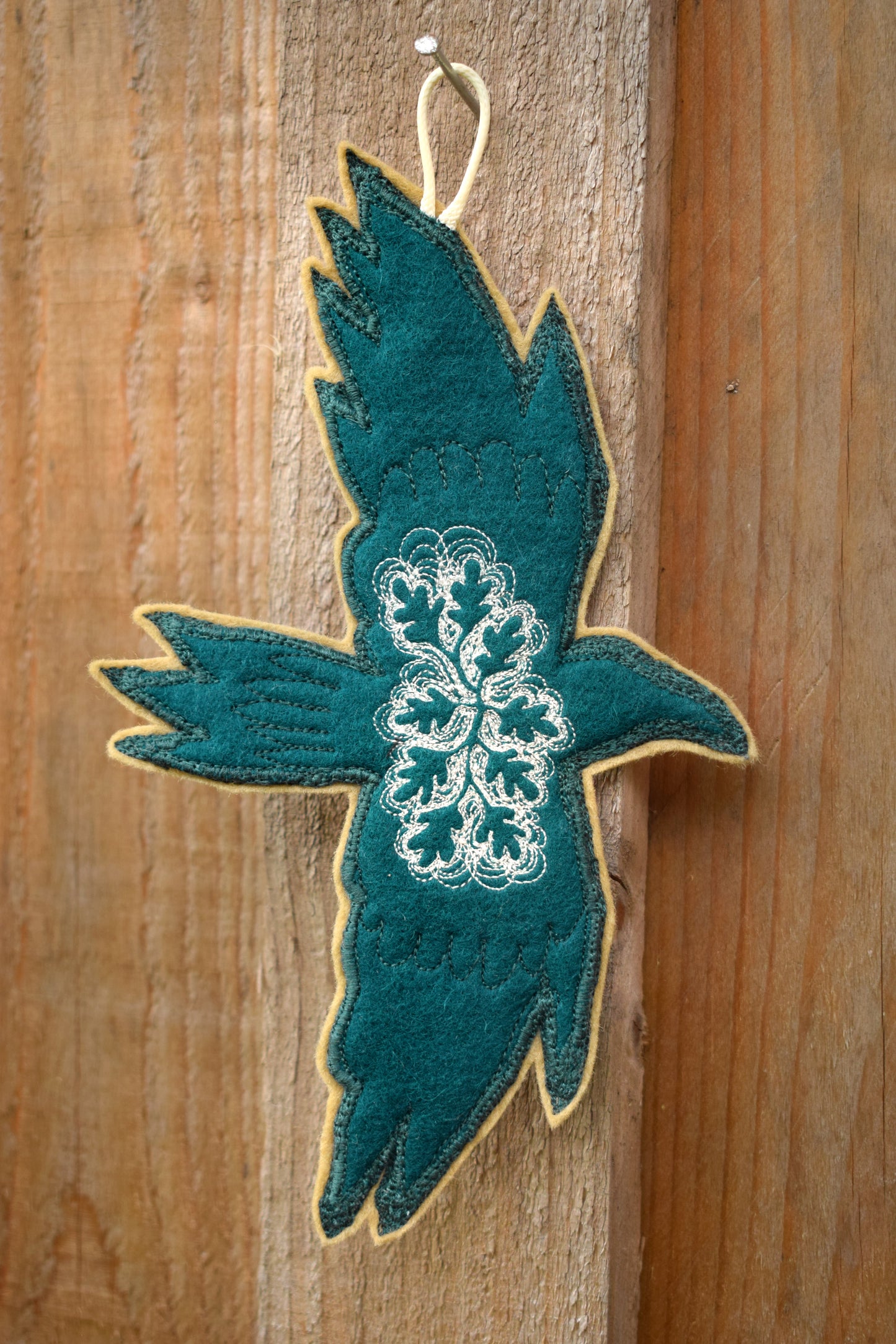 Embroidered leafy bird wall hanging