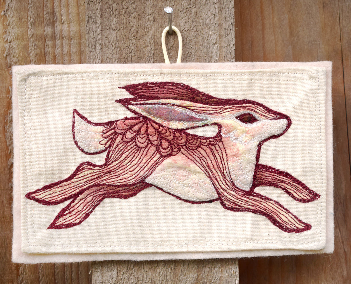 Embroidered hare wall hanging