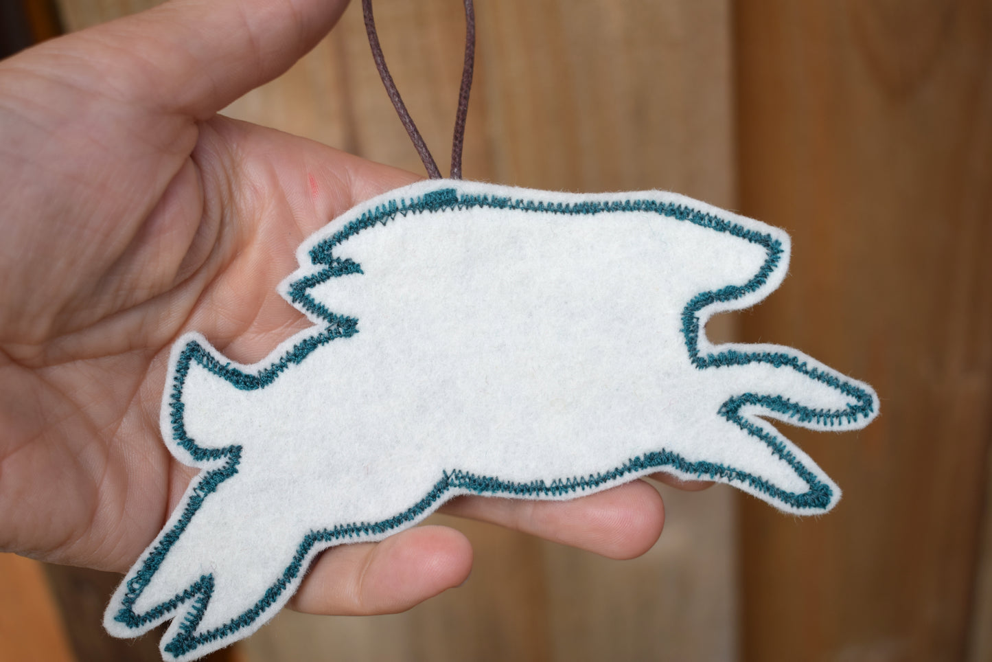 Embroidered felt hare wall hanging