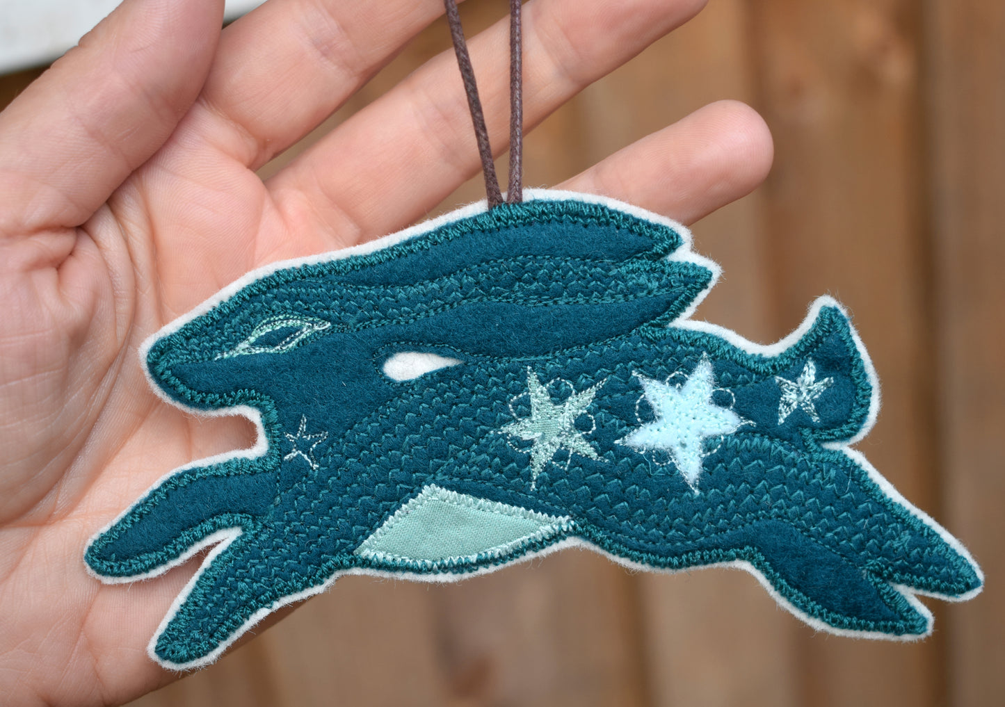 Embroidered felt hare wall hanging