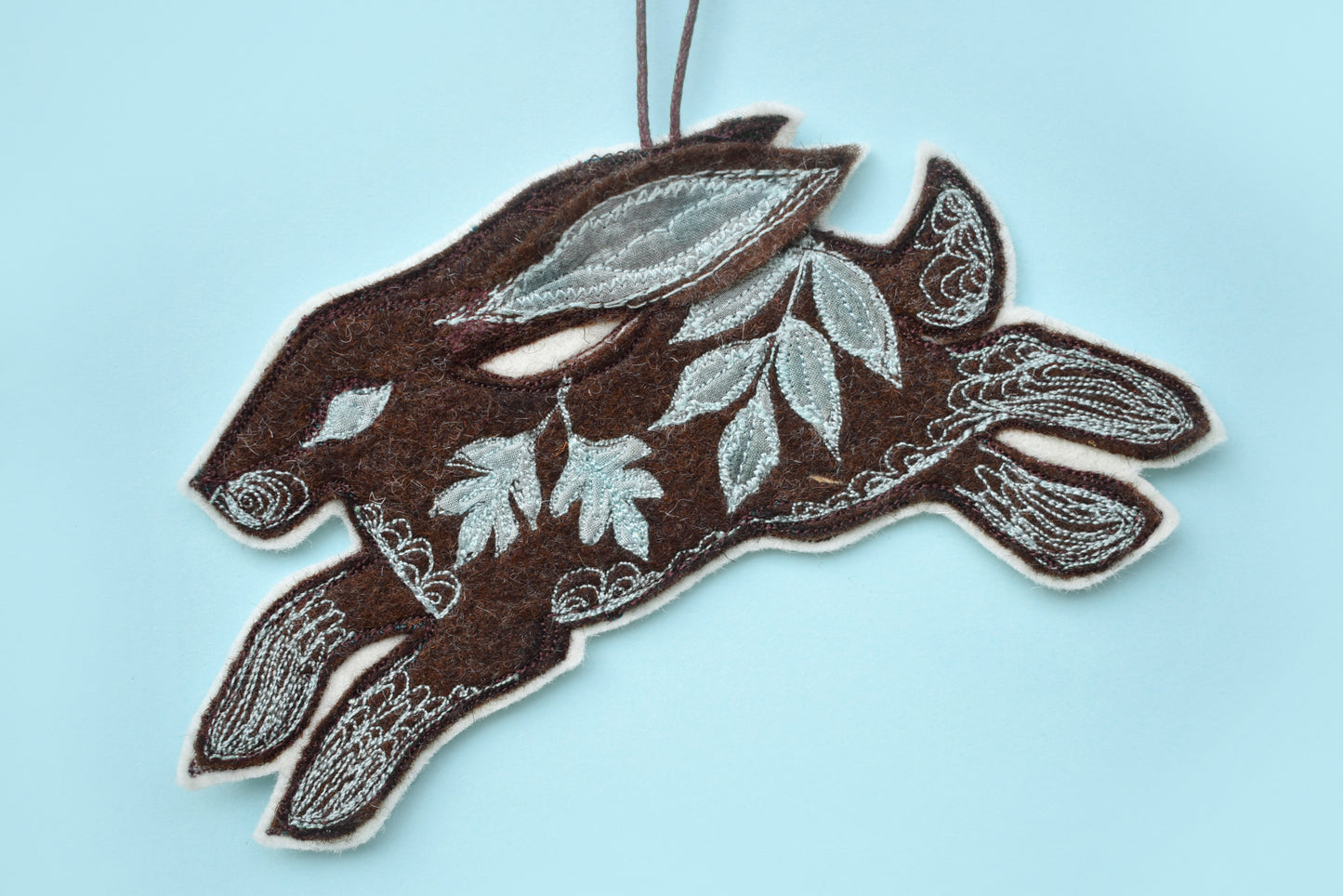 Embroidered felt and silk hare wall hanging