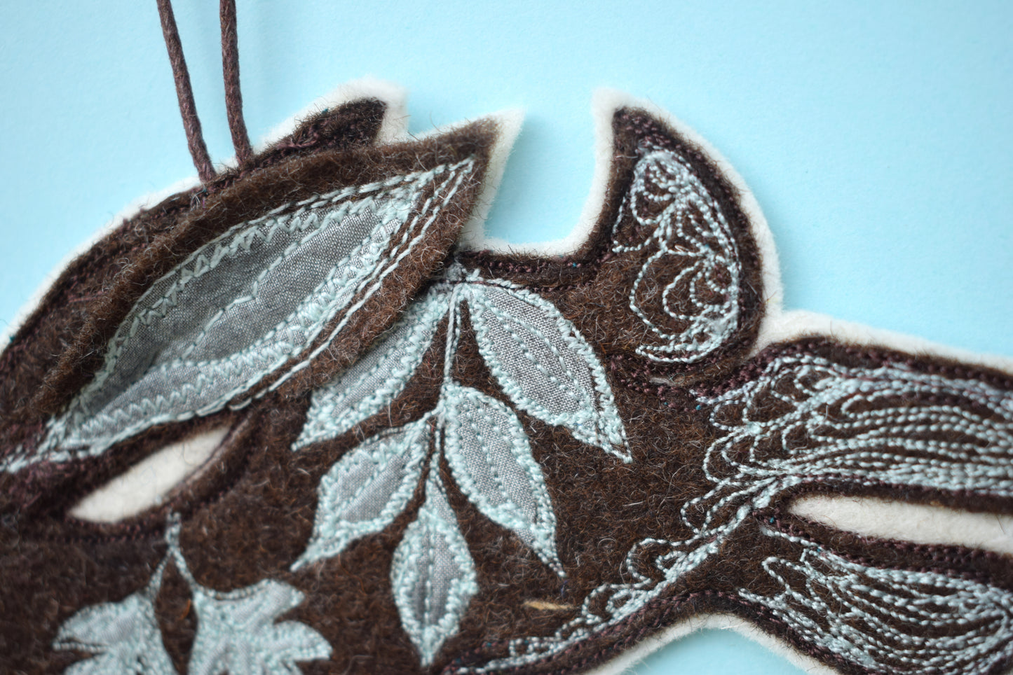 Embroidered felt and silk hare wall hanging